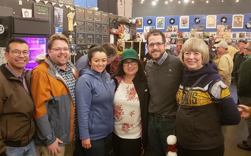 Six people standing together inside Berryessa Brewing during a civic gathering