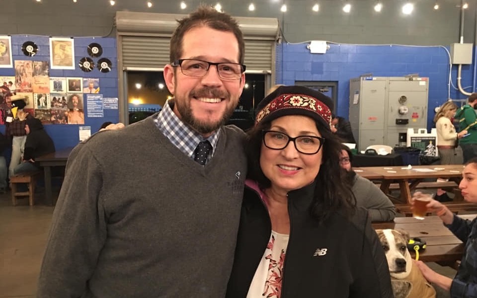 Two people standing together inside Berryessa Brewing during a regional civic gathering