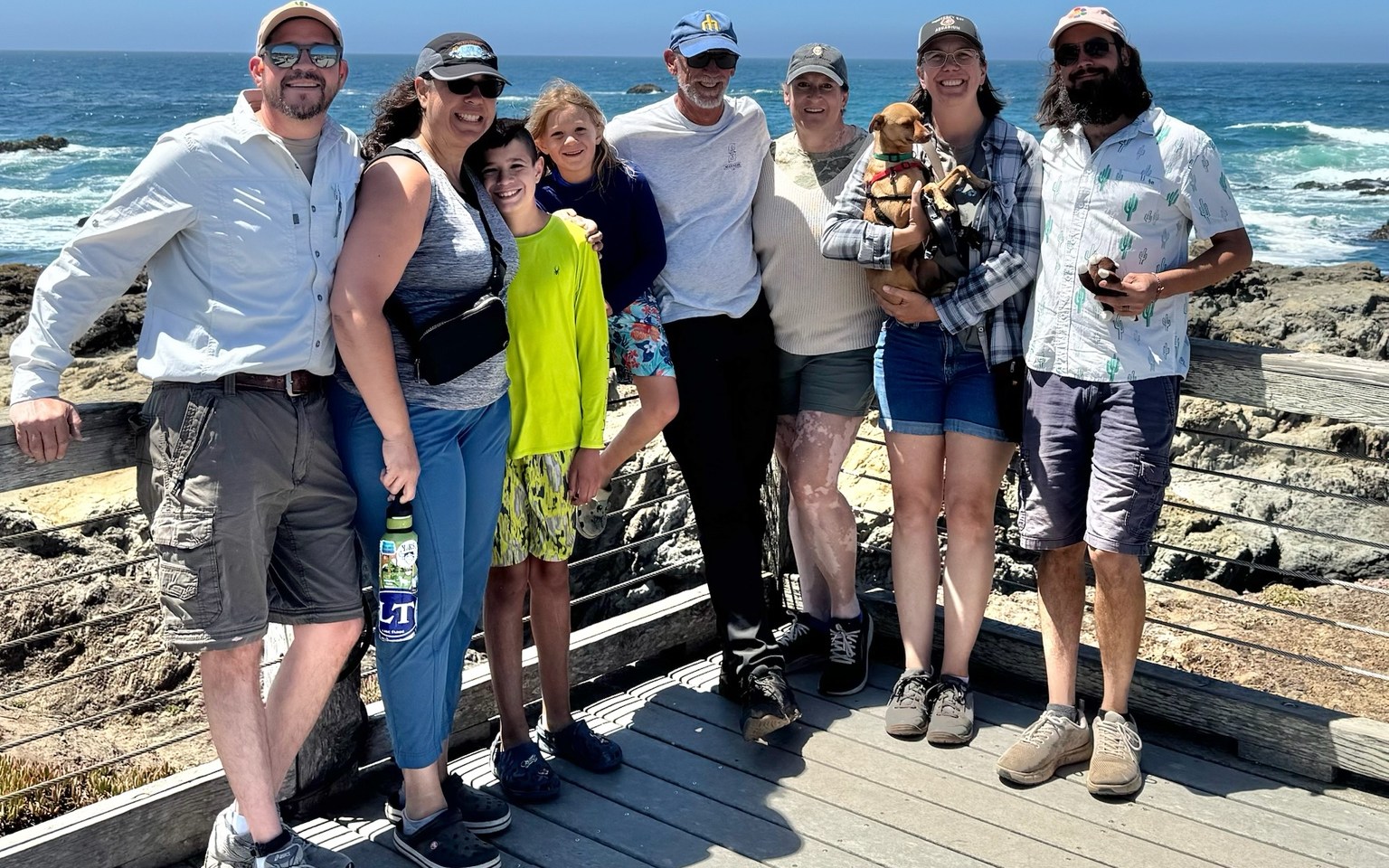 Extended family group standing together at a coastal overlook