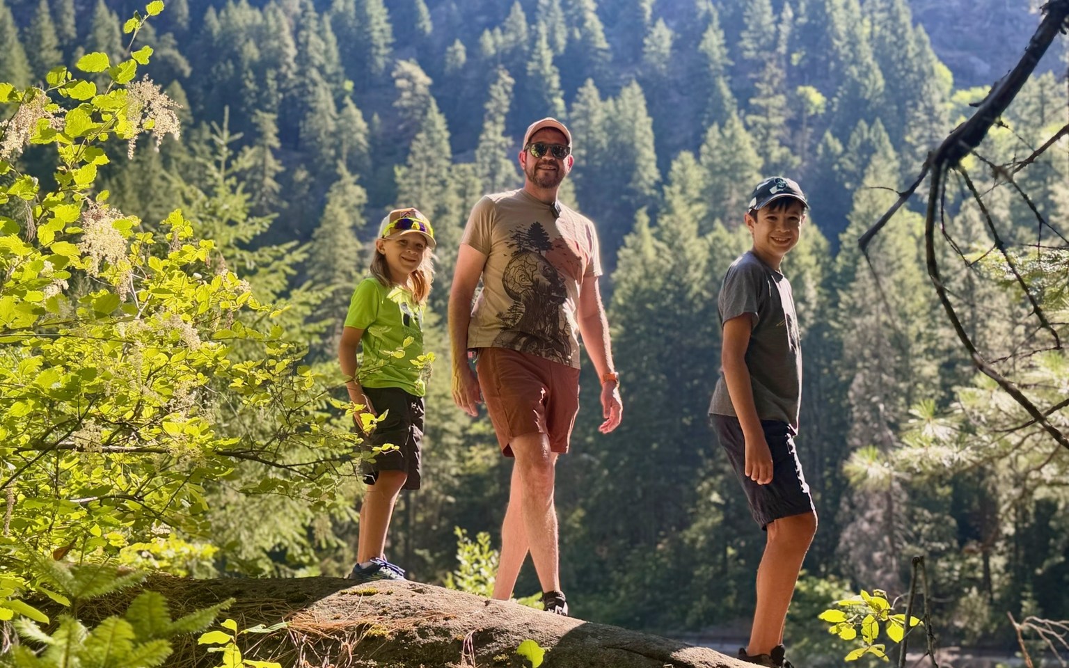 Randall Stone hiking with his two children in mountain country