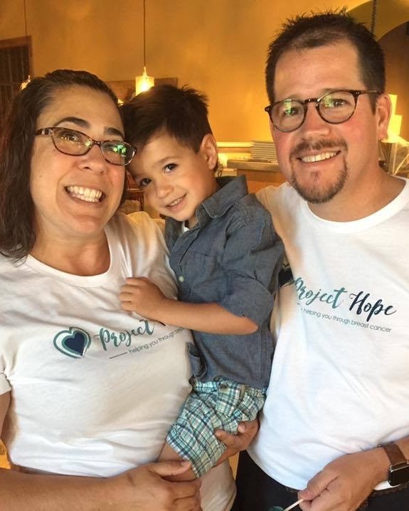Family wearing matching Project Hope shirts at a community event