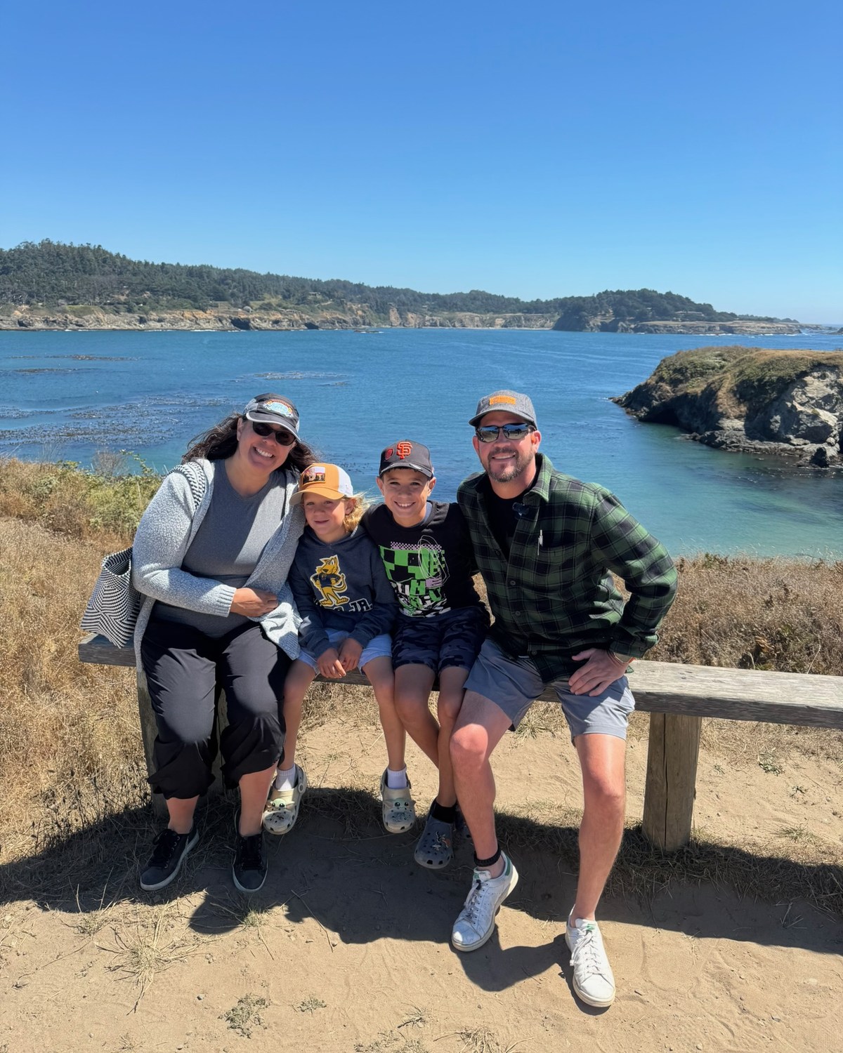 Stone family together above a rocky Northern California coastline