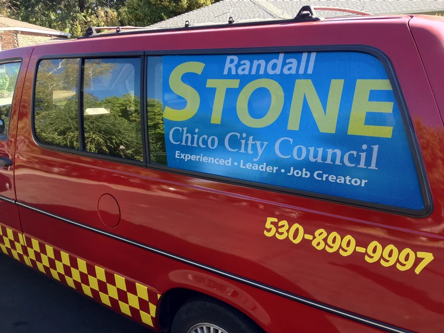 Taxi carrying a Randall Stone City Council campaign sign