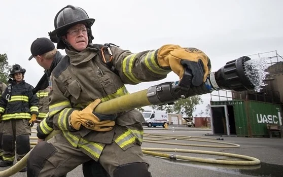 Randall Stone operating a charged fire hose during Citizens Academy training