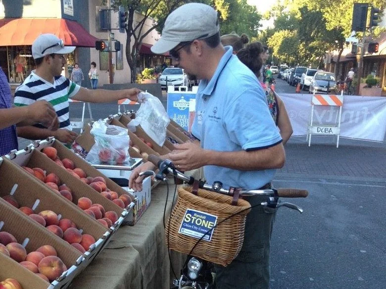 Randall Stone at the Downtown Thursday Night Market with a bicycle