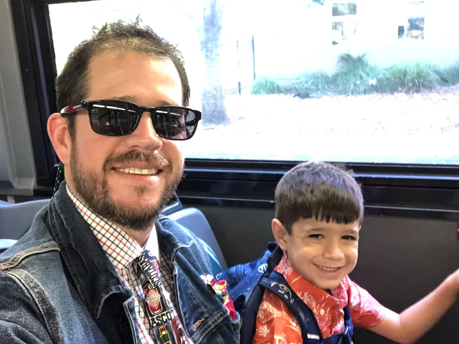 Randall Stone and one of his children riding B-Line transit