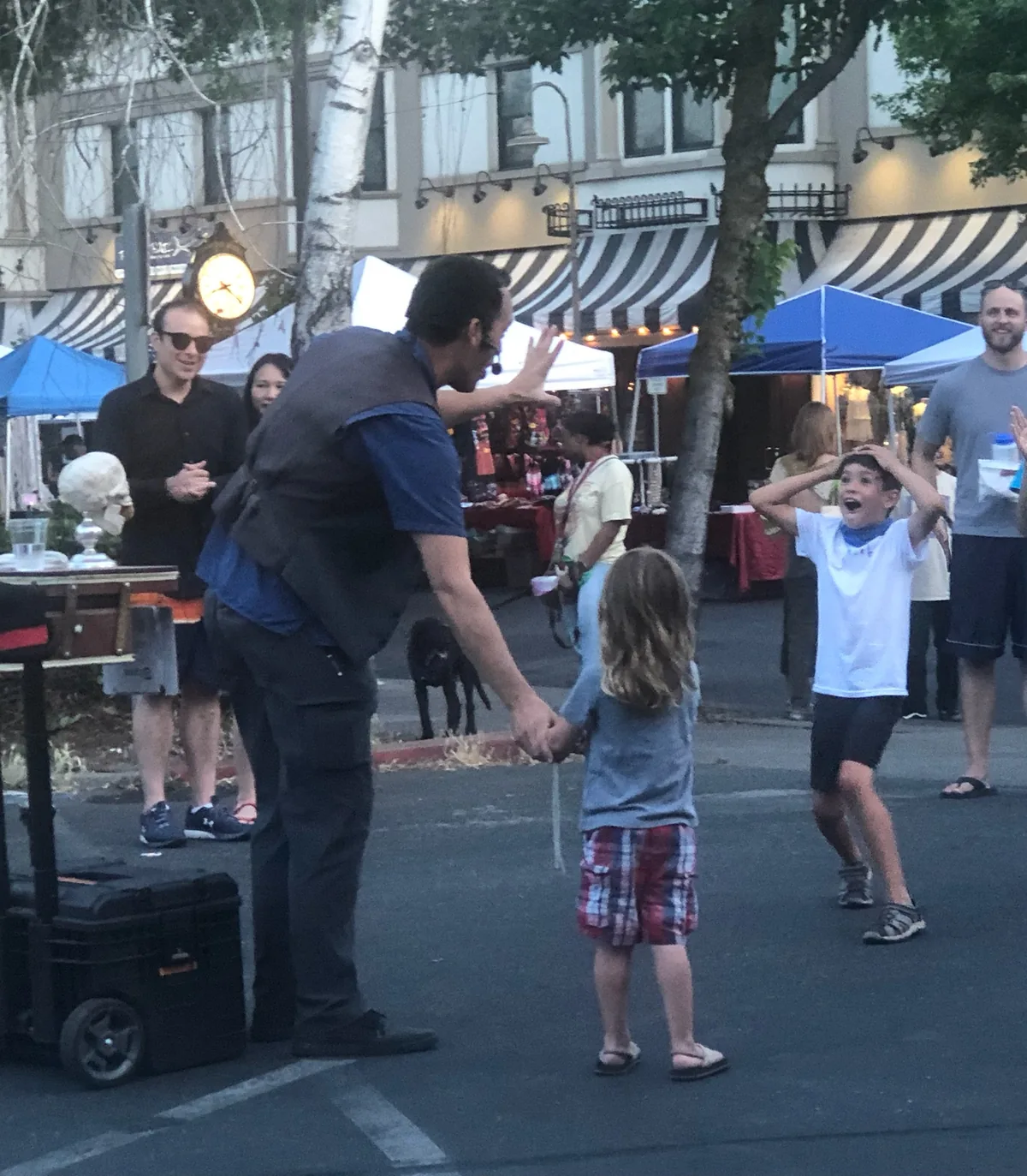 Children reacting to a live street performer in Chico