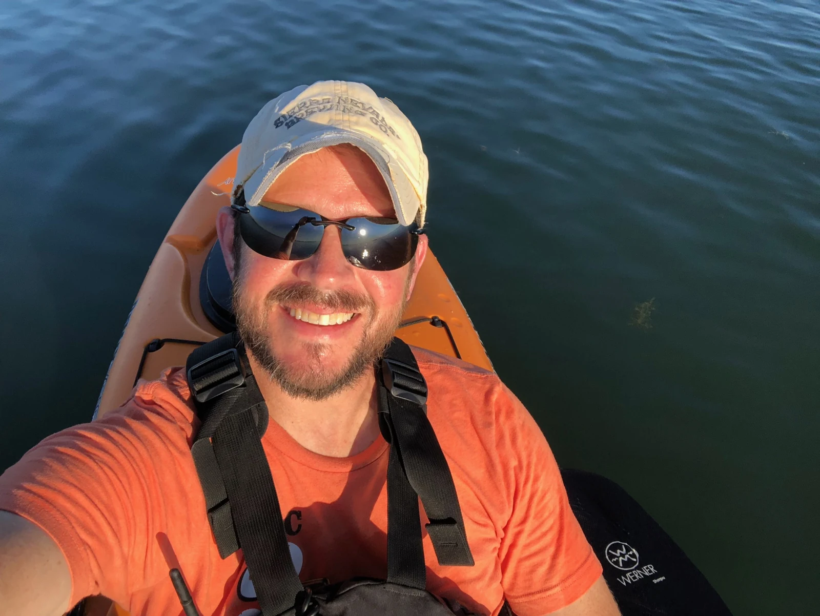 Randall Stone in an orange kayak on the water