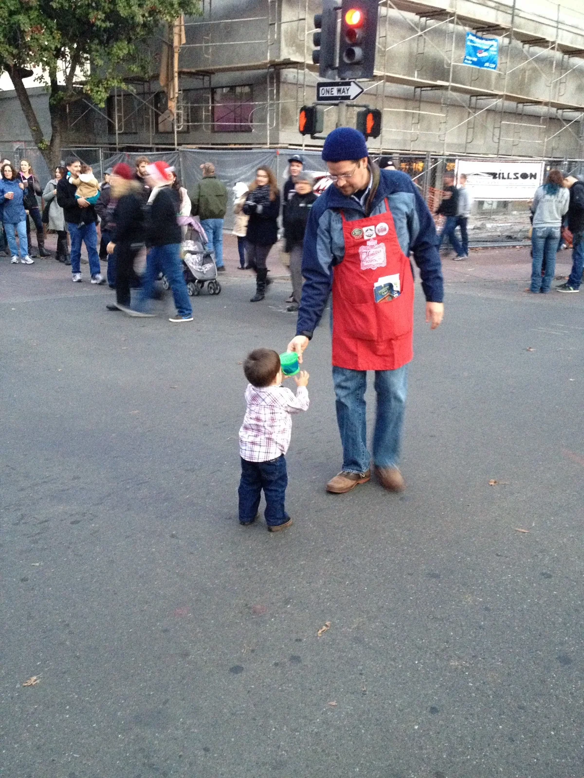 Randall Stone greeting visitors at Downtown Chico Christmas Preview with young Rhys at Third and Broadway