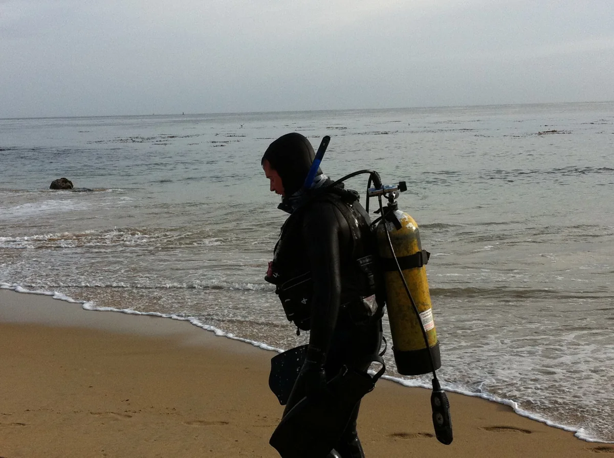 Randall Stone in scuba gear walking out from a coastal shore dive