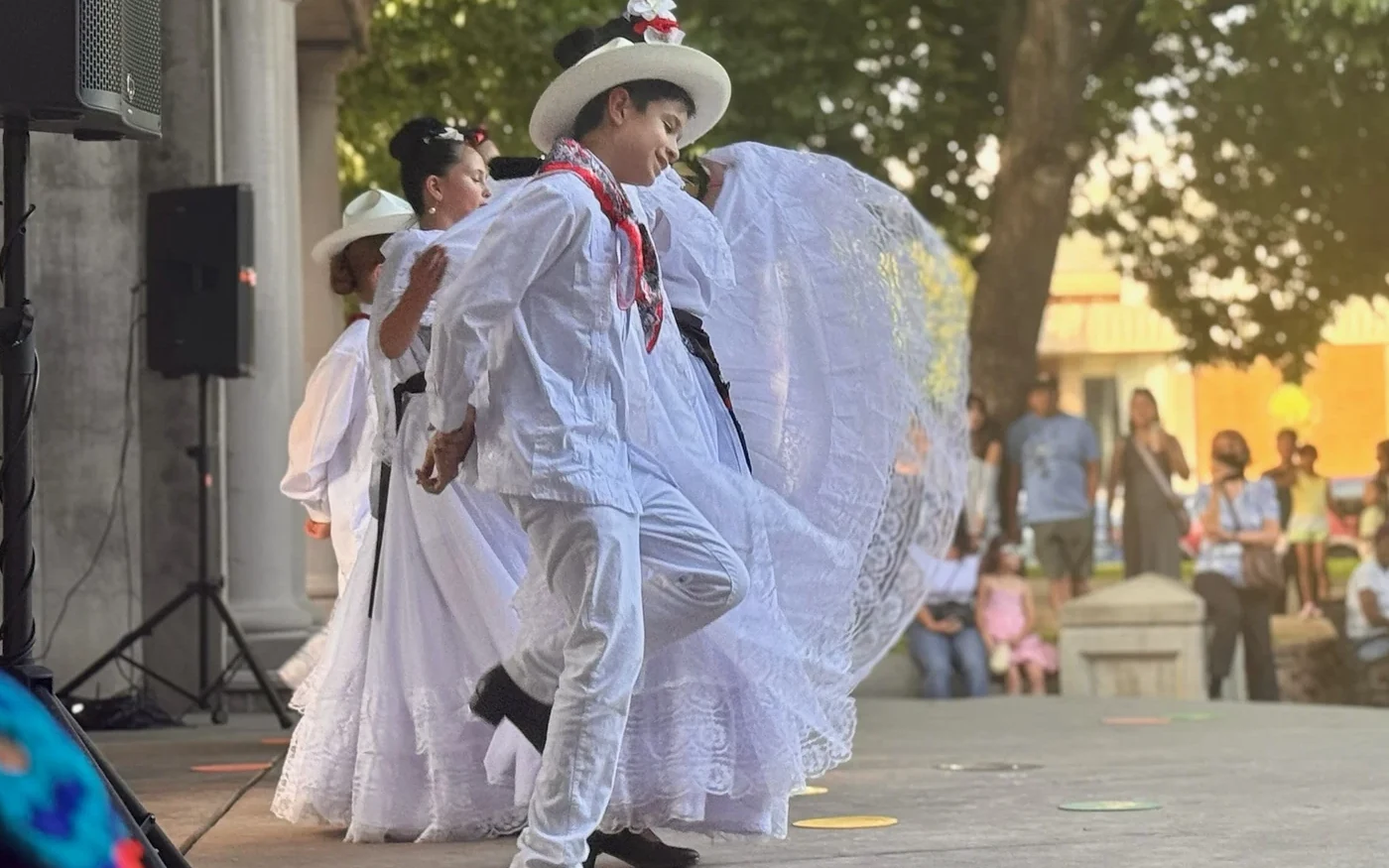 Rosas de María dancers in white performing folklórico with Chico City Hall in the background