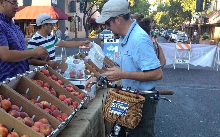 Randall Stone at the Downtown Chico Thursday Night Market with a bicycle