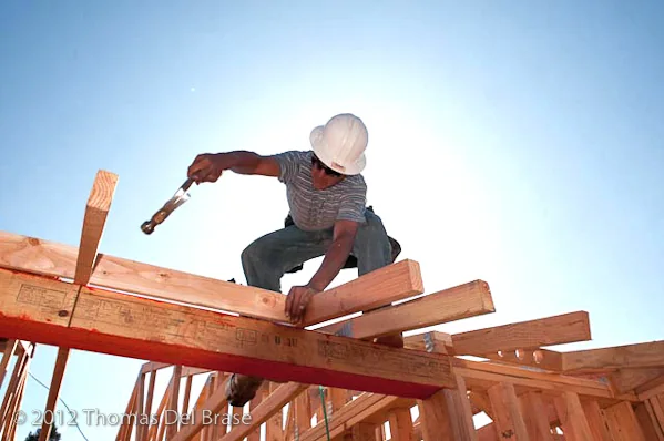 Worker framing Bidwell Park Apartments during construction