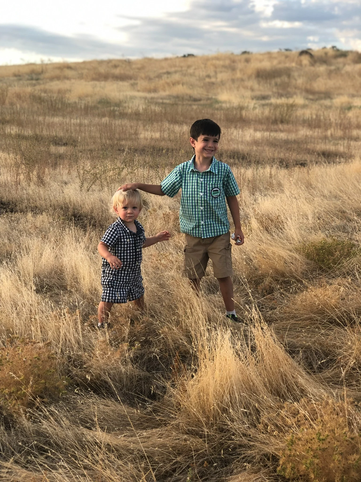 Rhys and Karden Stone standing together in a dry grass field
