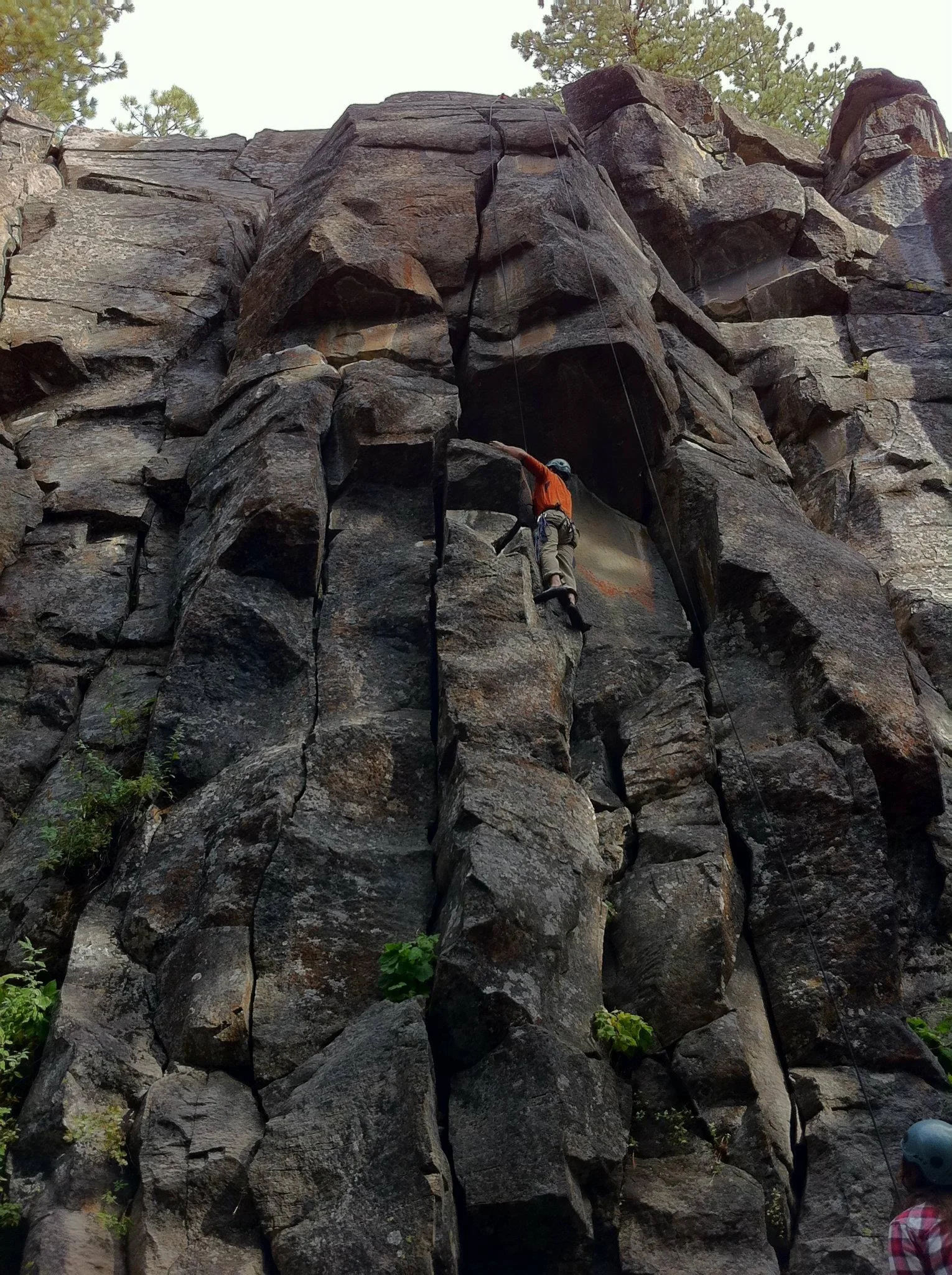 Randall Stone climbing an outdoor rock face on belay