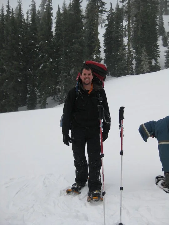 Randall Stone snowshoeing with a backpack in deep snow