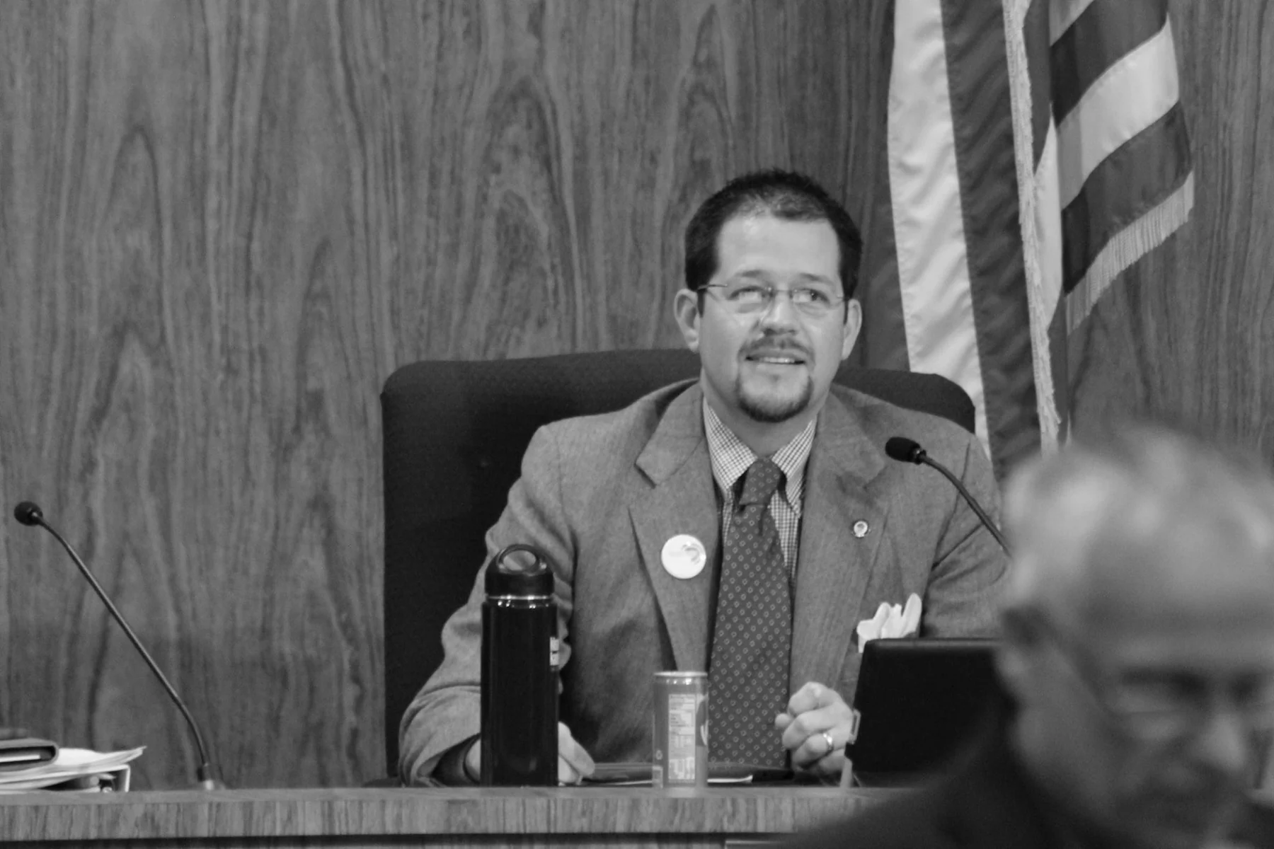 Black-and-white photograph of Randall Stone seated at the Chico City Council dais