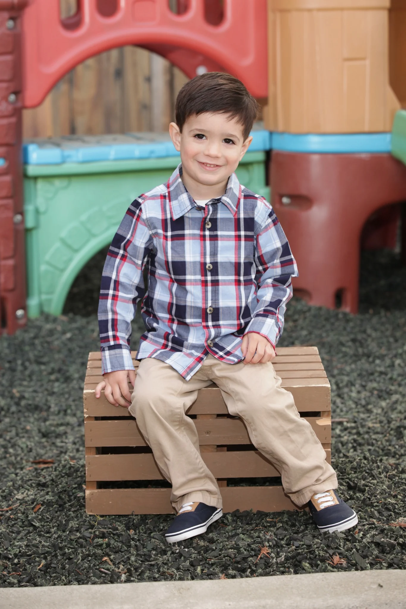 Rhys Stone seated outdoors for a childhood portrait