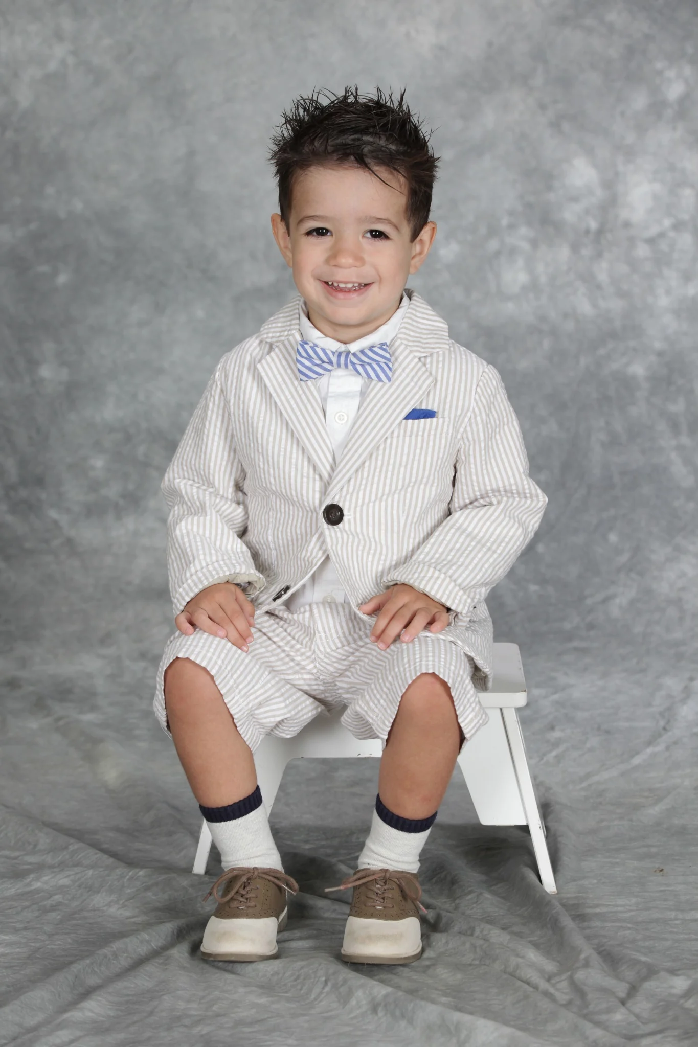 Rhys Stone smiling for a school portrait in a plaid shirt