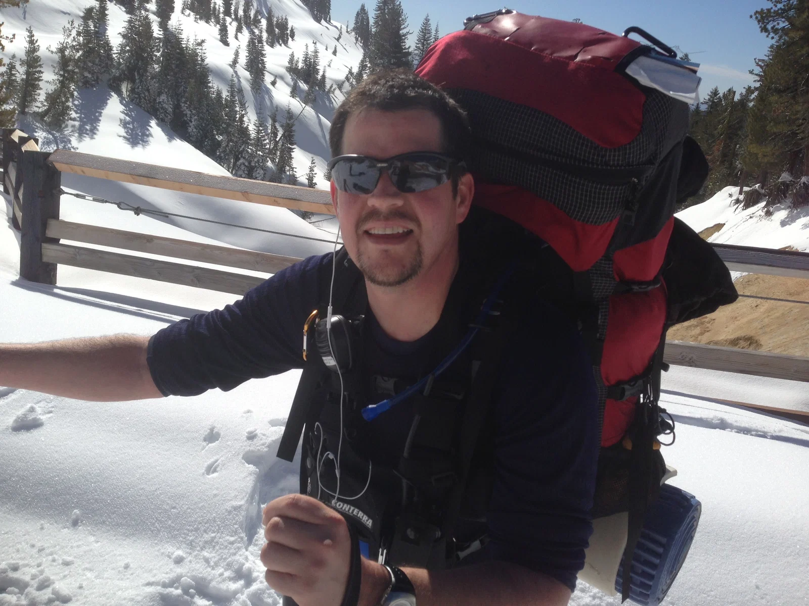 Randall Stone traveling through snowy mountain terrain with a backpack
