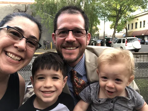 Stone family taking a casual outdoor selfie in 2019
