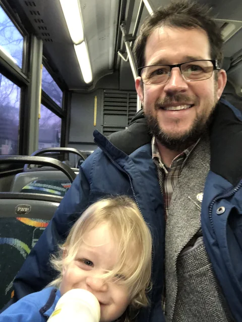 Randall Stone riding public transit with one of his children in 2020