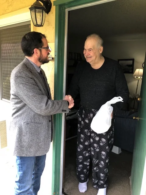 Randall Stone greeting a resident during a Chico Meals on Wheels delivery route