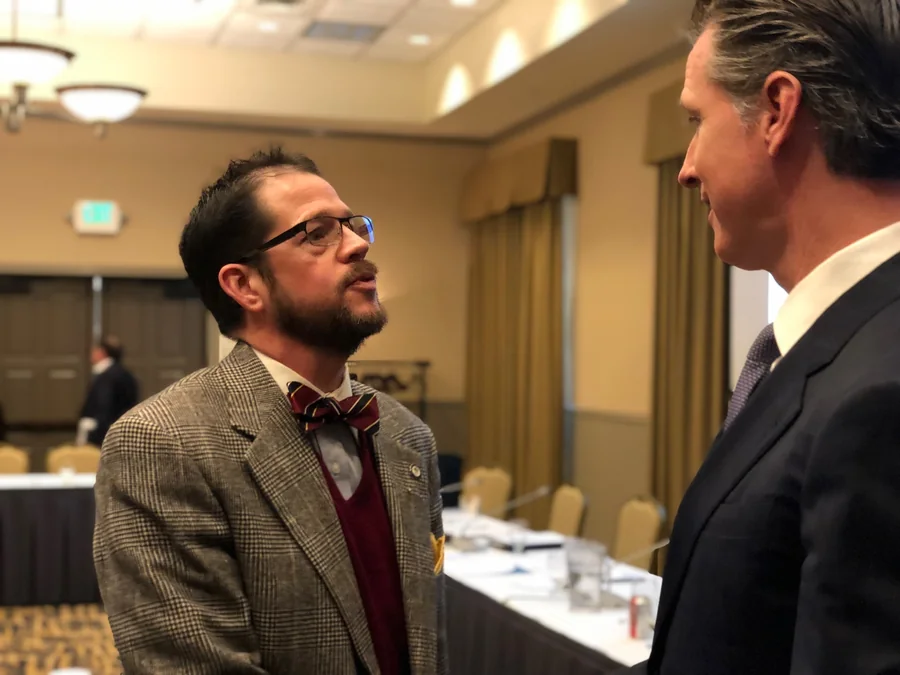 Randall Stone speaking directly with Gavin Newsom at a regional public-service event