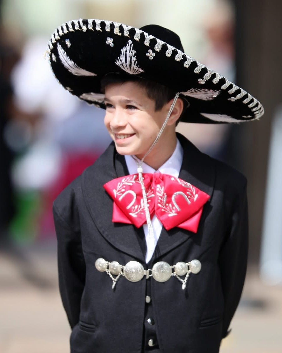 Smiling young Ballet Folklórico performer in charro attire