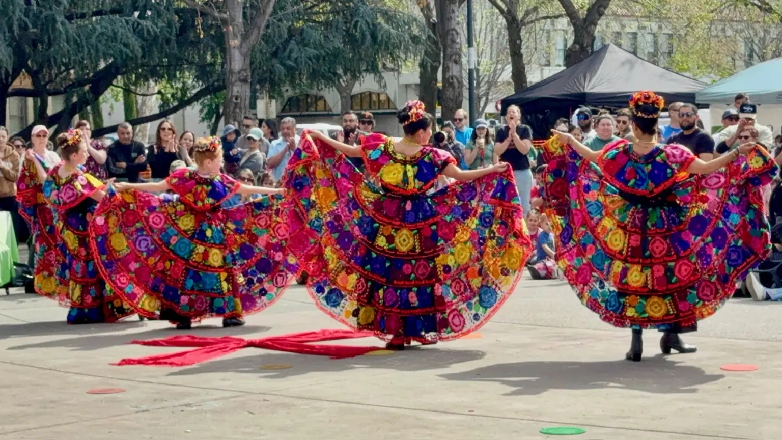 Rosas de María dancers performing in floral folklórico dresses